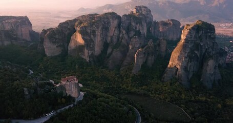 Wall Mural - Aerial scenic view of the famous Meteora flying monasteries in Greece at sunrise. A journey to the wonders of the world. Visit tourist attractions and landmarks