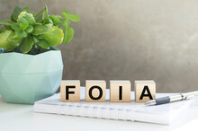 FOIA, text on wood cubes on light background, business concept