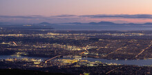 Vancouver Cityscape, British Columbia, Canada On The West Coast Of Pacific Ocean. Aerial Panoramic View At Sunset Twilight. Modern City Lights. Taken From Grouse Mountain.