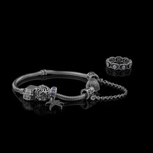 A Beautiful, Expensive Pandora Bracelet Lies On A Table On A Black Background