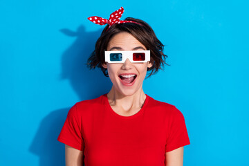 Canvas Print - Photo of impressed young brunette lady watch tv wear red t-shirt headband eyewear isolated on blue color background