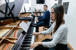 © ADDICTIVE STOCK - Man and woman playing piano during music lesson