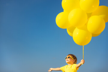 Wall Mural - Happy child playing outdoors in spring field