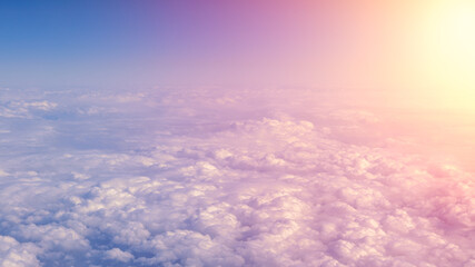 Wall Mural - Aerial traveling. Flying at dusk or dawn. Fly through orange cloud and sun.