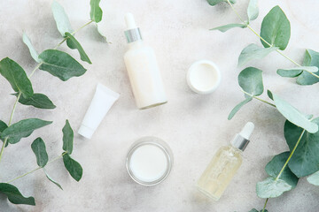 Wall Mural - transparent cosmetic packaging with eucalyptus leaves on stone table. spa natural organic beauty pro