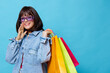 beautiful woman in denim jackets with colorful shopping bags isolated background