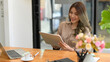 © bongkarn - Young entrepreneur woman using her digital tablet.