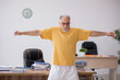 © Elnur - Old businessman employee doing sport exercises in the office