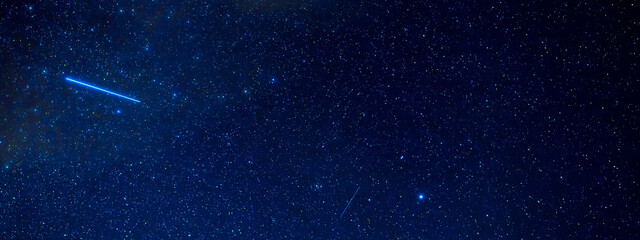 Wall Mural - Panorama of the starry sky at night with a shooting star against the background of many galaxies and universes