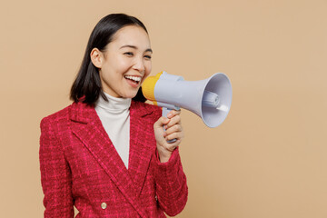 Poster - Smiling happy woman of Asian ethnicity 20s wear red jacket hold scream in megaphone announces discounts sale Hurry up isolated on plain pastel beige background studio People lifestyle fashion concept.