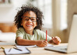 © JenkoAtaman - Smiling african american child school boy studying online on laptop at home