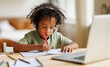© JenkoAtaman - Smiling african american child school boy in headphones studying online on laptop at home
