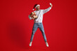 © Prostock-studio - Cheerful Man In Santa Hat Holding Gifts And Taking Selfie With Smartphone