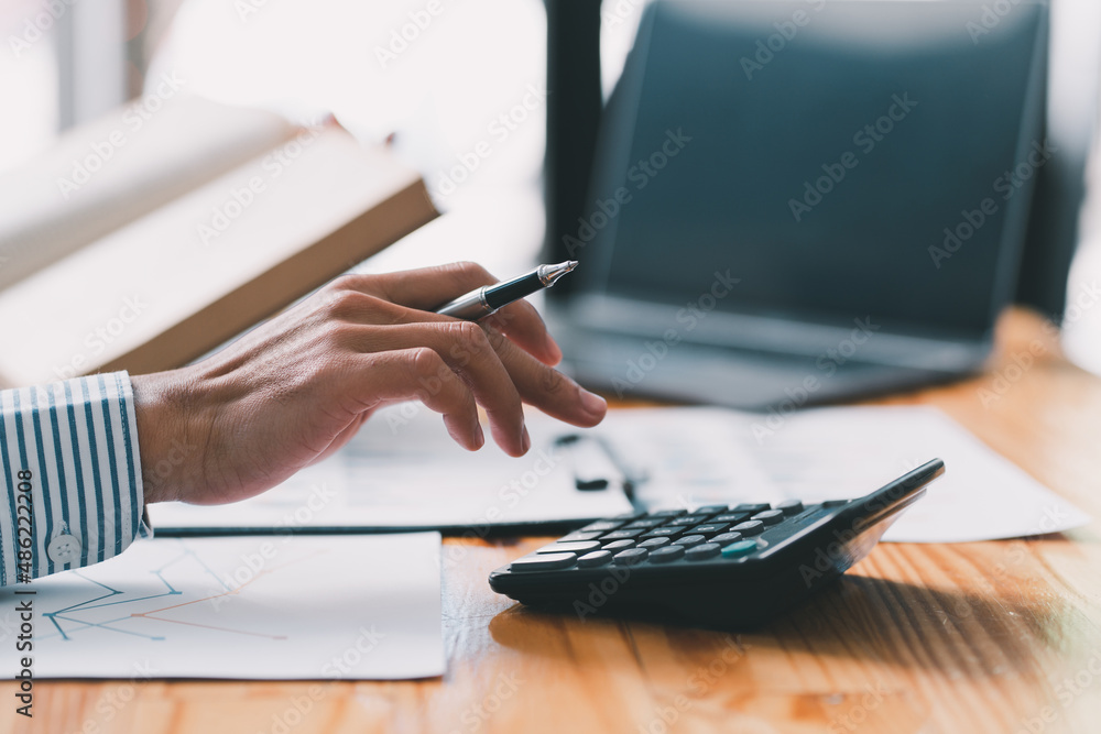Accounting businessman are calculating income expenditure and analyzing real estate investment data, Dedicated to the progress and growth of the company, Financial and tax systems concept.