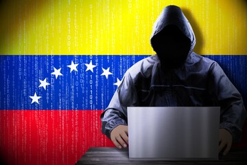 Anonymous hooded hacker, flag of Venezuela, binary code - cyber attack concept
