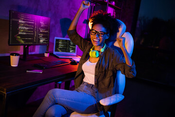 Photo of crazy lady freelancer fists up success software match operating system sit desk in modern late workplace workstation