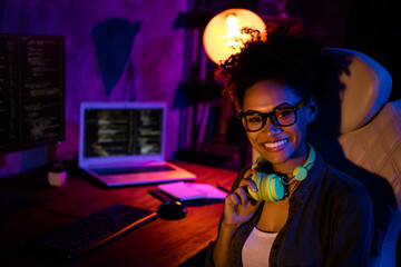 Photo of happy lady freelancer earphones sit desk ready esport tournament in modern professional evening late workplace workstation