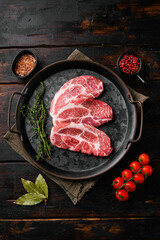 Wall Mural - Fresh raw pork neck meat, on old dark  wooden table background, top view flat lay