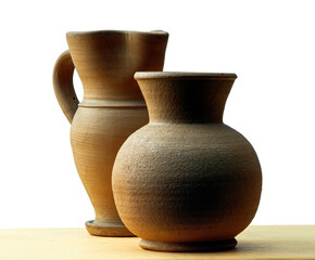 Two little handcrafted clay jars on white background