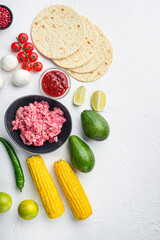 Wall Mural - Mexican tacos with vegetables and meat. Ingredient for cooking, Top view over white background with space for text.