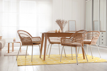 Wall Mural - Dining room interior with wooden table and wicker chairs