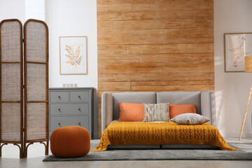 Sticker - Room interior with sofa unfolded into bed near wooden wall