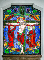  A stained glass window of christ on the cross in one of the ornate tombs at La Recoleta Cemetery in Buenos Aires