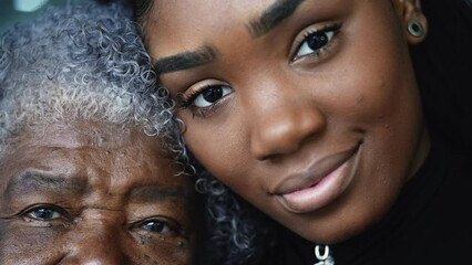 Wall Mural - Generational women portrait faces a grandmother and granddaughter posing for camera together