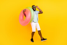 Full Length Body Size View Of Attractive Trendy Cheery Guy Carrying Life Buoy Having Fun Isolated Over Bright Yellow Color Background