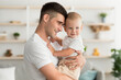 © Prostock-studio - Father's Love. Happy Millennial Daddy Bonding With Cute Infant Son At Home