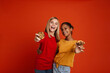 © Drobot Dean - Multiracial two girls hugging while making fun with cookies