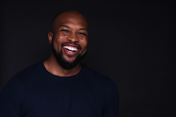 Studio portrait of young man on black background