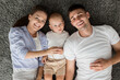 © Prostock-studio - Top View Portrait Of Happy Young Parents And Cute Toddler Baby