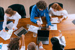 © master1305 - Training new employee. Aerial view of young multiethnic people talking, working with colleagues, co-workers at office, indoors. Work, finance, tech concept.