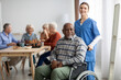 © Prostock-studio - Happy older patient on wheelchair with female nurse