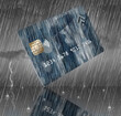 Credit card saved for rainy day. Here is a generic mock credit card or debit card with a man with umbrella in the rain. This is a 3-d illustration and a modern design for 2022...