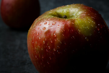 Poster - A close-up shot of an apple with some water drops on it.