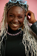 Studio portrait of smiling woman with bleached braided hair