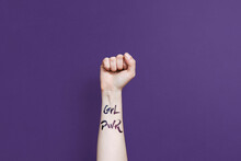 Clenched Fist With Girl Power Phrase On Purple Background