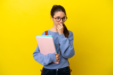 Canvas Print - Student kid woman over isolated yellow background having doubts