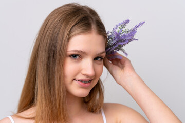 teenager russian girl isolated on white background holding a lavender plant. close up portrait