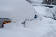 Snow-covered car, under a pile of snow, after a snowstorm