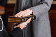 partial view of bailiff holding bible near woman giving swear in court