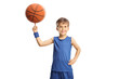 Boy in a blue jersey spinning a basketball