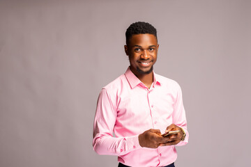 handsome man in isolated over white background smiling as he operates his phone