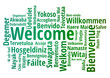 © MARTINFFFF - WELCOME word cloud in different languages, concept green text on white background