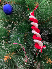 Poster - A vertical shot of some decorations on a Christmas tree.