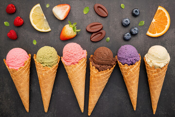 Fototapete - Flat lay ice cream cones collection on dark stone background . Blank crispy ice cream cone with copy space for sweets menu design.