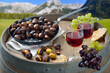 Beim Törggelen in Südtirol mit gerösteten Keschtn und Schüttelbrot serviert mit jungem Rotwein auf einem Weinfass - Wine tasting in South Tyrol with roasted chestnuts and the local crunchy rye bread