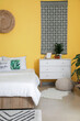 © Pixel-Shot - Stylish interior of modern bedroom with yellow wall